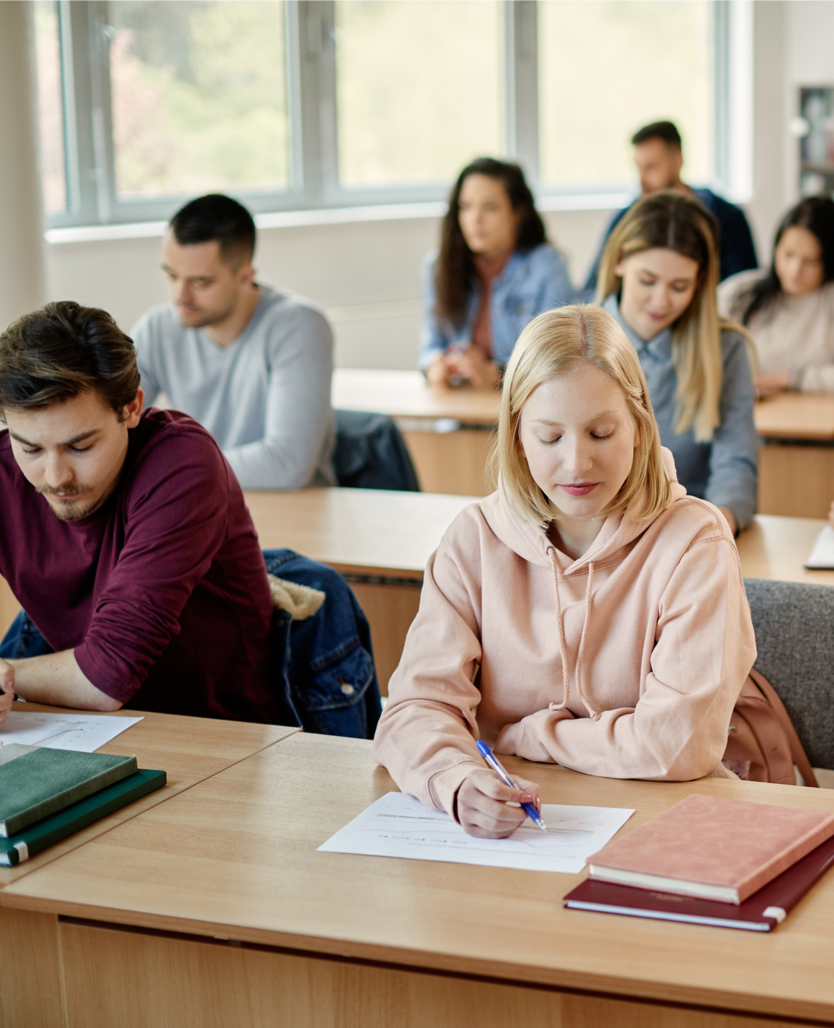 Students taking a test in classroom setting.